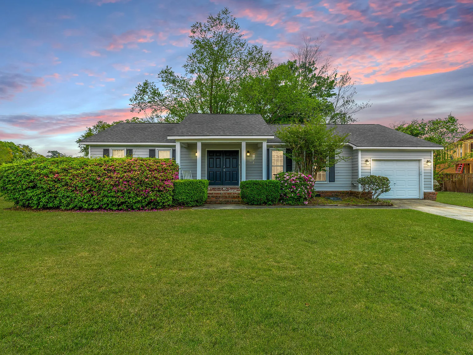 Manicured front yard with new bushes after landscaping